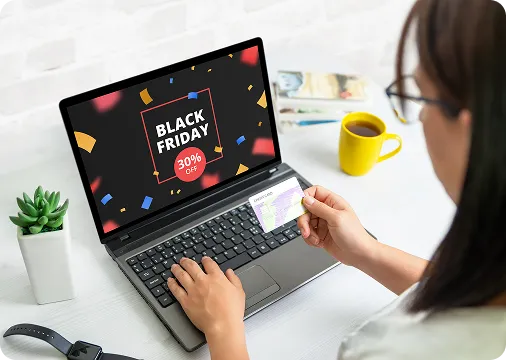 A customer uses OrderEazi's user-friendly platform to shop a Black Friday sale, showcasing a 30% off promotion on the laptop screen.