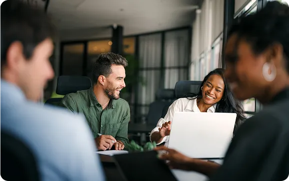 A diverse team engages in a friendly office meeting.