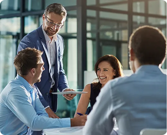 A diverse group of professionals engage in an animated business meeting.