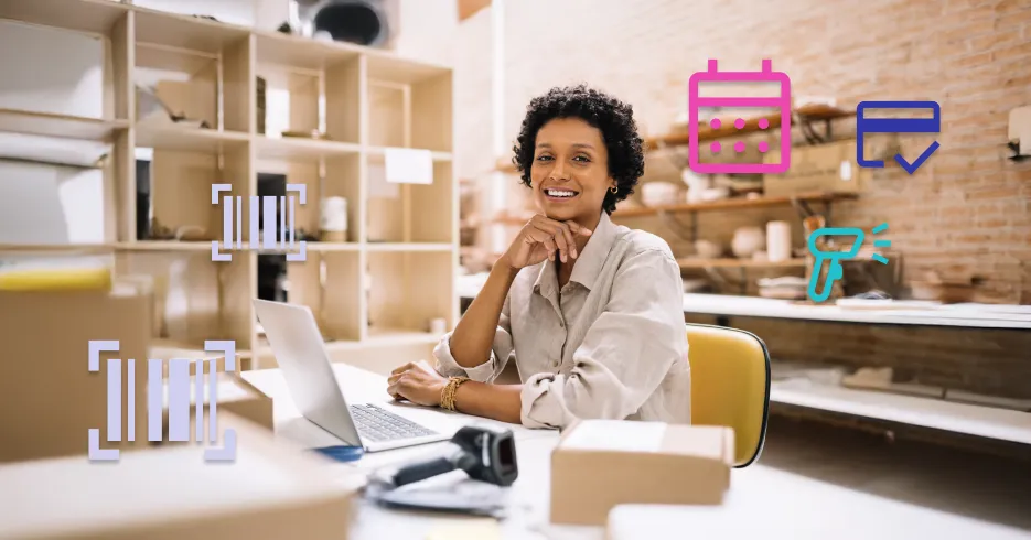 Smiling businesswoman using laptop in a warehouse office, surrounded by digital icons representing inventory management and scheduling tools.