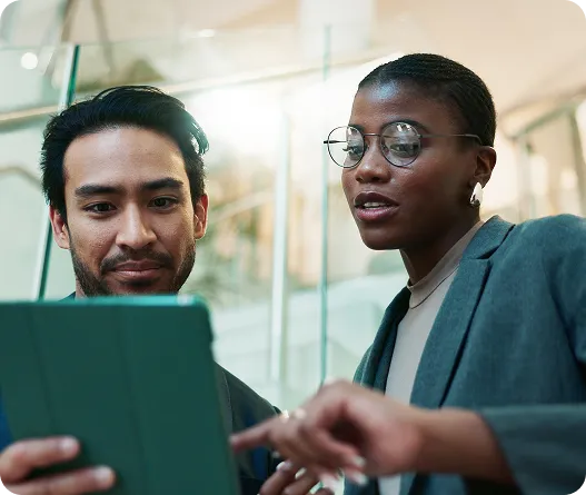 Two diverse professionals collaborating in an office setting.