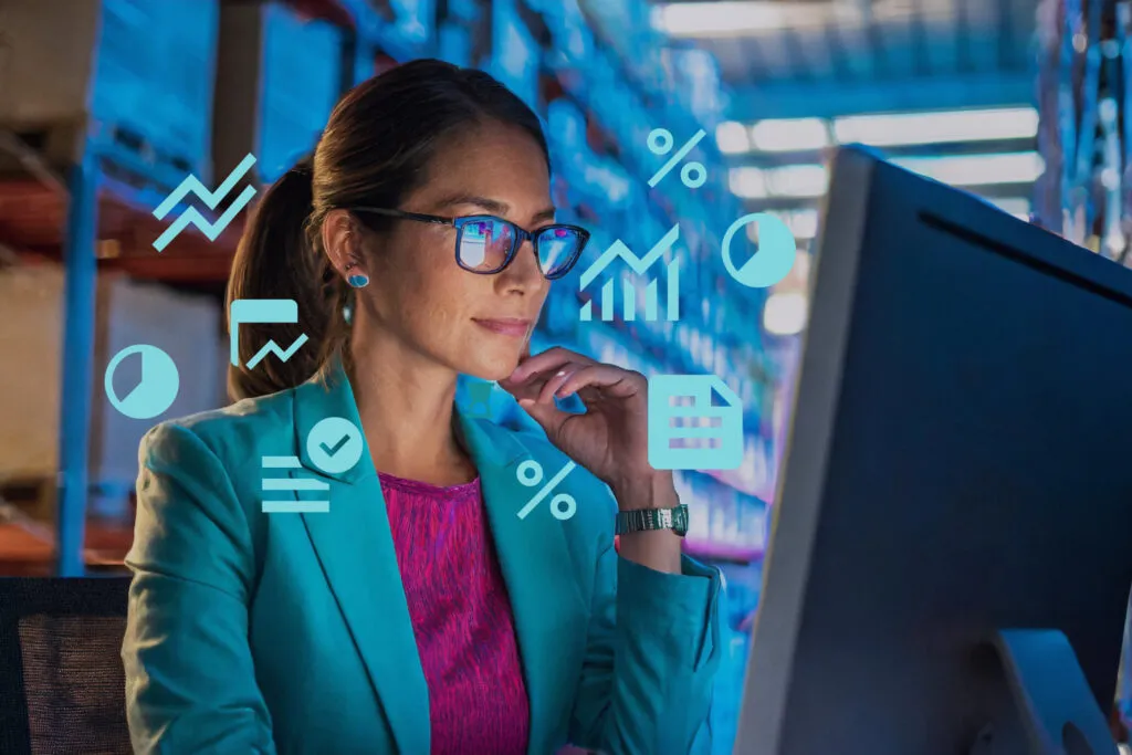 Businesswoman analysing real-time data on computer screen, surrounded by digital analytics icons, demonstrating OrderEazi's powerful business intelligence capabilities.